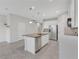 Eat-in kitchen features granite countertops and an island with modern appliances at 2690 Pleasant Cypress Cir, Kissimmee, FL 34741