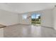 Bright living room area with tile flooring and a large sliding glass door to the backyard at 2690 Pleasant Cypress Cir, Kissimmee, FL 34741