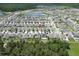 Wide aerial view showcasing the property in relation to neighborhood and surrounding natural environment at 2727 Harmonia Hammock Rd, Harmony, FL 34773