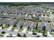 Real estate aerial view showing homes near a lake and fountain at 2727 Harmonia Hammock Rd, Harmony, FL 34773