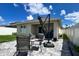 Backyard patio with stylish seating arrangement, providing an ideal outdoor space for relaxation and entertainment at 2727 Harmonia Hammock Rd, Harmony, FL 34773