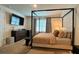 Spacious bedroom with a four-poster bed, dresser, and ample natural light at 2727 Harmonia Hammock Rd, Harmony, FL 34773