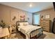 Inviting bedroom with a comfortable bed, desk, and dresser, creating a serene and functional space at 2727 Harmonia Hammock Rd, Harmony, FL 34773