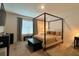 Bedroom with a four-poster bed, neutral tones, and soft natural lighting at 2727 Harmonia Hammock Rd, Harmony, FL 34773