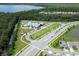 Aerial view of community center with modern pool, playground, parking, and easy access to natural waterways at 2727 Harmonia Hammock Rd, Harmony, FL 34773