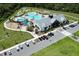 Aerial view of the community pool with a modern pool, playground, and ample parking at 2727 Harmonia Hammock Rd, Harmony, FL 34773