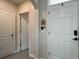 Neat front entrance with a clean white door, providing a welcoming transition to the home's interior at 2727 Harmonia Hammock Rd, Harmony, FL 34773