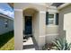 Inviting front entrance with a stylish teal door, lovely wreath, and tasteful landscaping enhancing curb appeal at 2727 Harmonia Hammock Rd, Harmony, FL 34773
