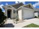 Charming home entrance with a clean, freshly-painted front door and rock landscaping for an inviting aesthetic at 2727 Harmonia Hammock Rd, Harmony, FL 34773