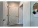 View of the hallway featuring neutral walls, tiled floors and white doors at 2727 Harmonia Hammock Rd, Harmony, FL 34773