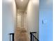 Bright hallway with neutral walls and carpet leads to various rooms, enhancing the home's flow at 2727 Harmonia Hammock Rd, Harmony, FL 34773