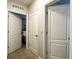 Hallway with carpet and neutral walls lead to multiple rooms creating a clean and inviting space at 2727 Harmonia Hammock Rd, Harmony, FL 34773