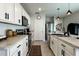 Kitchen with stainless steel appliances, white cabinets, and granite countertops at 2727 Harmonia Hammock Rd, Harmony, FL 34773