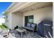 Charming patio with string lights, furniture, grill and sliding glass door at 2727 Harmonia Hammock Rd, Harmony, FL 34773