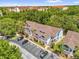 Aerial view of the condos, showing parking and lush surrounding trees at 2737 N Poinciana Blvd # 92, Kissimmee, FL 34746