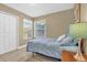 Bright bedroom features neutral walls, tile flooring, a double window, and closet at 2737 N Poinciana Blvd # 92, Kissimmee, FL 34746