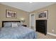 Cozy bedroom with a decorative pillow, artwork, and black dresser at 2737 N Poinciana Blvd # 92, Kissimmee, FL 34746