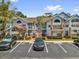 Attractive condominium exterior features a light blue facade and manicured landscaping at 2737 N Poinciana Blvd # 92, Kissimmee, FL 34746