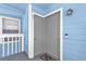 Close up of the front door featuring blue siding and welcome mat at 2737 N Poinciana Blvd # 92, Kissimmee, FL 34746