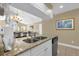 Modern kitchen view showcases granite counters, stainless sink, and views to the living room at 2737 N Poinciana Blvd # 92, Kissimmee, FL 34746