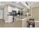 Well-lit kitchen with stainless steel appliances, breakfast bar, and granite countertops at 2737 N Poinciana Blvd # 92, Kissimmee, FL 34746