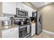 Updated kitchen featuring stainless steel appliances, granite countertops, and white cabinetry at 2737 N Poinciana Blvd # 92, Kissimmee, FL 34746