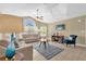 Bright living room with vaulted ceilings, tile floors, large windows, ceiling fan, and comfortable furnishings at 2737 N Poinciana Blvd # 92, Kissimmee, FL 34746
