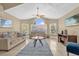 Cozy living room showcasing vaulted ceilings, large windows, neutral tones, and comfortable seating arrangement at 2737 N Poinciana Blvd # 92, Kissimmee, FL 34746