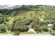 Aerial view of large, wooded lot outlined in red with house nestled in the trees at 2810 Horton Rd, Kissimmee, FL 34744