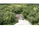 An aerial view of a home nestled among lush trees on a large lot at 2810 Horton Rd, Kissimmee, FL 34744