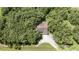 An aerial view of the home, nestled among a canopy of mature trees at 2810 Horton Rd, Kissimmee, FL 34744