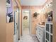 Bathroom featuring a white vanity, arched opening to a separate toilet room, and orange color scheme at 2810 Horton Rd, Kissimmee, FL 34744