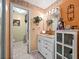 Bathroom featuring a white vanity, arched opening to a separate toilet room, and orange color scheme at 2810 Horton Rd, Kissimmee, FL 34744