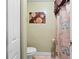 Small toilet room with toilet, tile flooring, olive green walls, and a patterned shower curtain at 2810 Horton Rd, Kissimmee, FL 34744