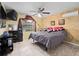 A bedroom with a bed, ceiling fan, window with curtains, tile flooring and a dresser at 2810 Horton Rd, Kissimmee, FL 34744