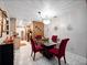 Bright dining room featuring tile floors, modern chandelier, and seating for four, open to the kitchen at 2810 Horton Rd, Kissimmee, FL 34744