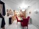 Bright dining room featuring tile floors, modern chandelier, and seating for four, open to the kitchen at 2810 Horton Rd, Kissimmee, FL 34744