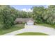 A single-story home with attached two-car garage, long driveway, and mature landscaping at 2810 Horton Rd, Kissimmee, FL 34744