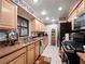 Well-lit kitchen with wood cabinets, stainless steel appliances, tile floors and decorative border near the ceiling at 2810 Horton Rd, Kissimmee, FL 34744