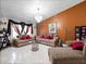 A living room featuring tile floors, chandelier, neutral-toned furnishings and large windows at 2810 Horton Rd, Kissimmee, FL 34744