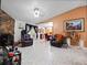 Open concept living room and dining area with tile floors, fireplace and views of the kitchen at 2810 Horton Rd, Kissimmee, FL 34744