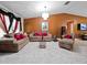 A living room featuring tile floors, chandelier, and neutral-toned furnishings at 2810 Horton Rd, Kissimmee, FL 34744