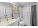 Clean bathroom featuring a tub with shower, white vanity, and framed botanical art at 2867 Club Cortile Cir, Kissimmee, FL 34746