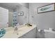 Bright bathroom with white vanity, large mirror, and a bathtub-shower combination at 2867 Club Cortile Cir, Kissimmee, FL 34746