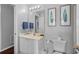 Clean bathroom with a vanity, framed art, and ample lighting at 2867 Club Cortile Cir, Kissimmee, FL 34746
