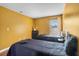 Inviting bedroom with two twin beds, hardwood floors, and ample natural light at 2867 Club Cortile Cir, Kissimmee, FL 34746