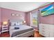 Cozy bedroom with a large bed, soft lighting, and a bright window at 2867 Club Cortile Cir, Kissimmee, FL 34746