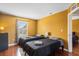 Sunny bedroom with two twin beds, hardwood floors, and a window view at 2867 Club Cortile Cir, Kissimmee, FL 34746