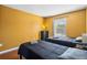 Cozy bedroom with two twin beds, hardwood floors, and natural light from the window at 2867 Club Cortile Cir, Kissimmee, FL 34746
