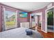Bedroom with modern sliding closet doors, a large window, and a mounted TV at 2867 Club Cortile Cir, Kissimmee, FL 34746